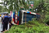 Bus overturns near Kapu due to sudden braking in heavy rain; several passengers injured